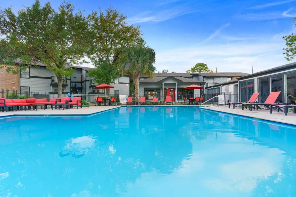 Community swimming pool with lounge seating at Falls of Gessner
